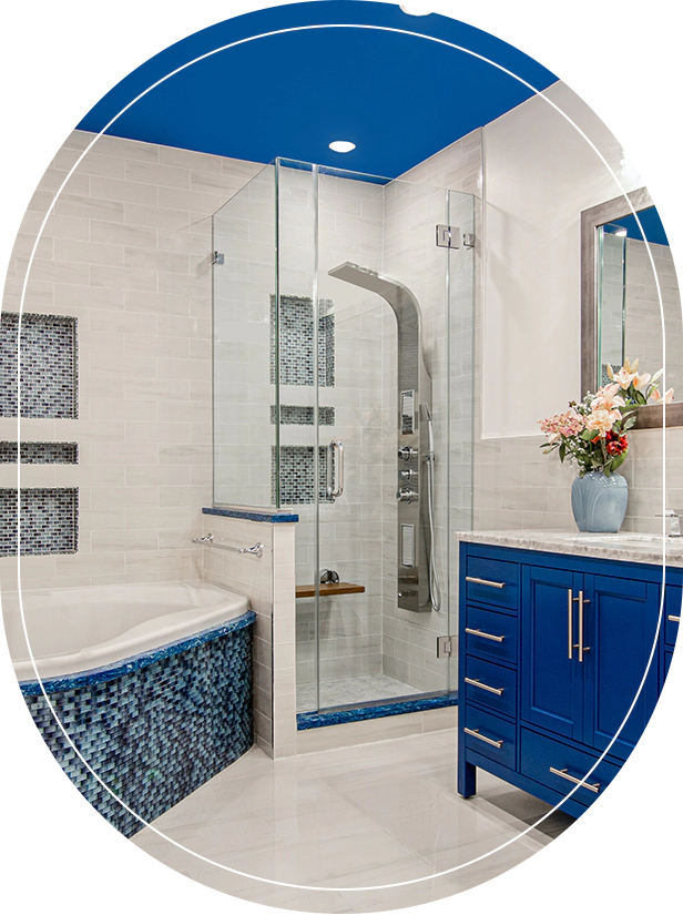 A bathroom with blue and white tile, a tub, shower and sink.