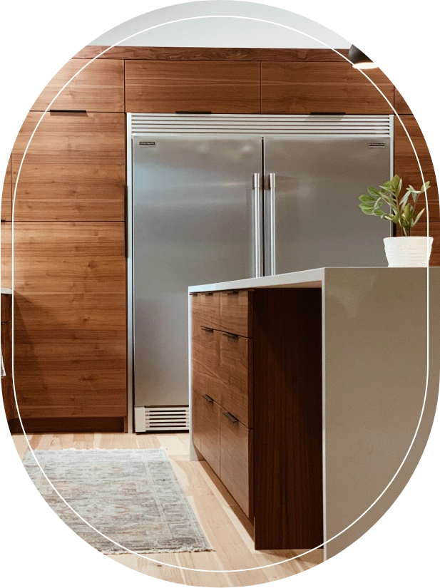 A kitchen with wood paneling and stainless steel appliances.