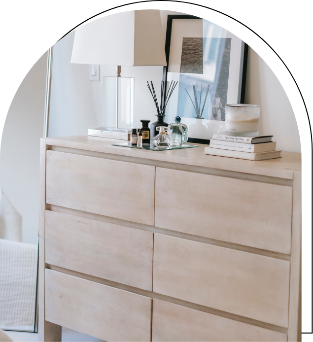 A dresser with many drawers and a mirror