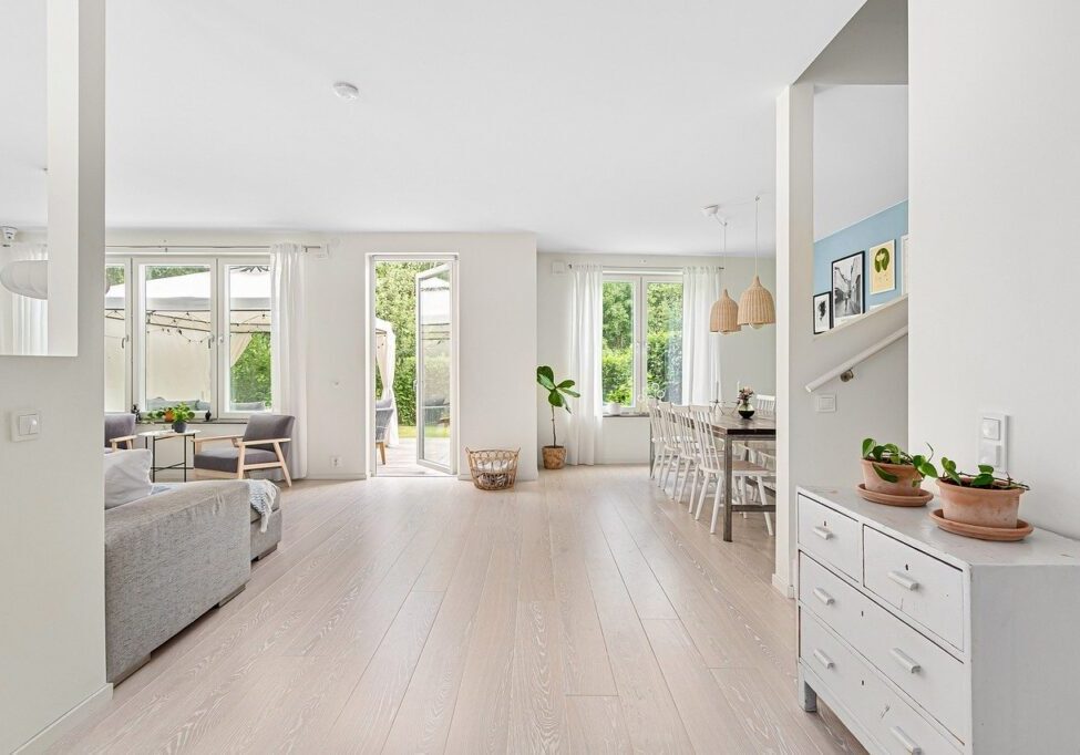 A living room with white walls and wooden floors.