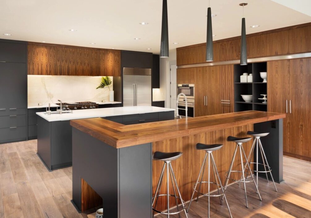 A kitchen with wooden cabinets and black counter tops.