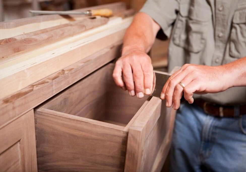 A person is working on something in a box.