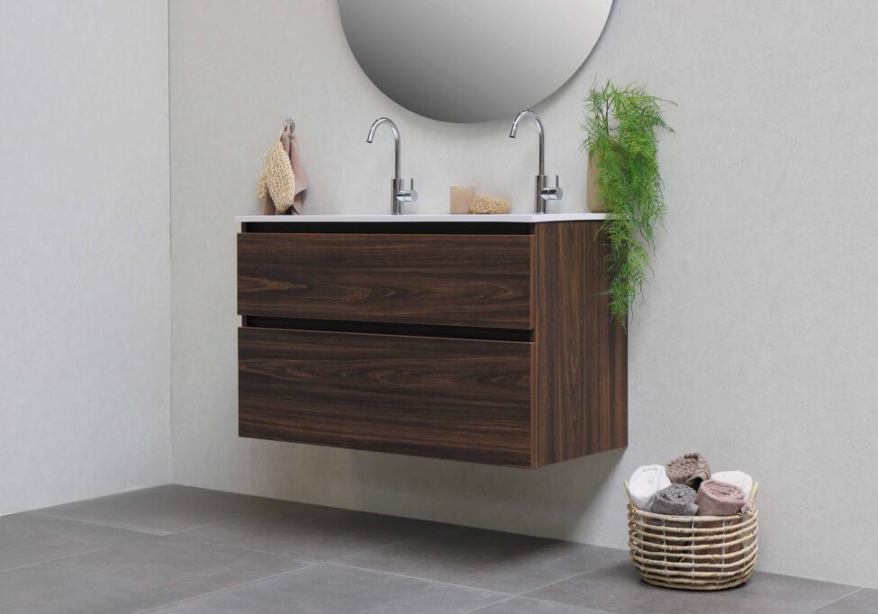 A bathroom with two sinks and a mirror.